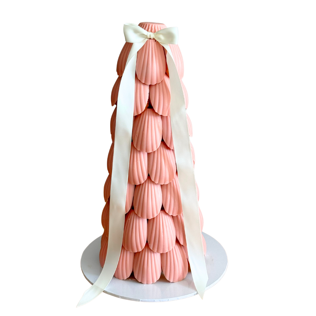 Pink madeleine cake tower glazed in soft pink chocolate, styled as an event dessert centrepiece for baby showers and birthdays in Melbourne and Adelaide.