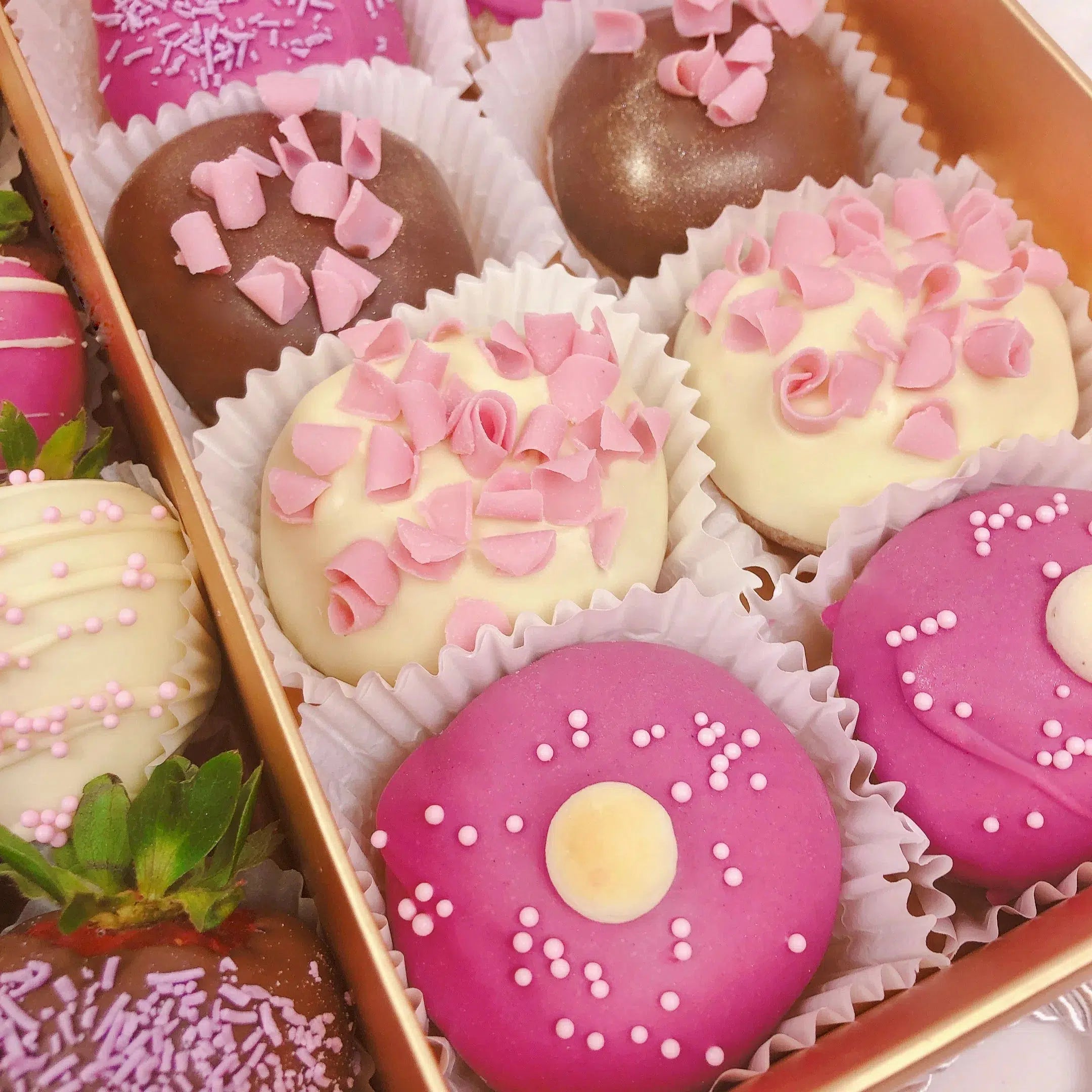 Mini doughnuts covered in white and pink chocolate decorated with delicious toppings fresh strawberries covered in finest Belgian chocolate hamper for her