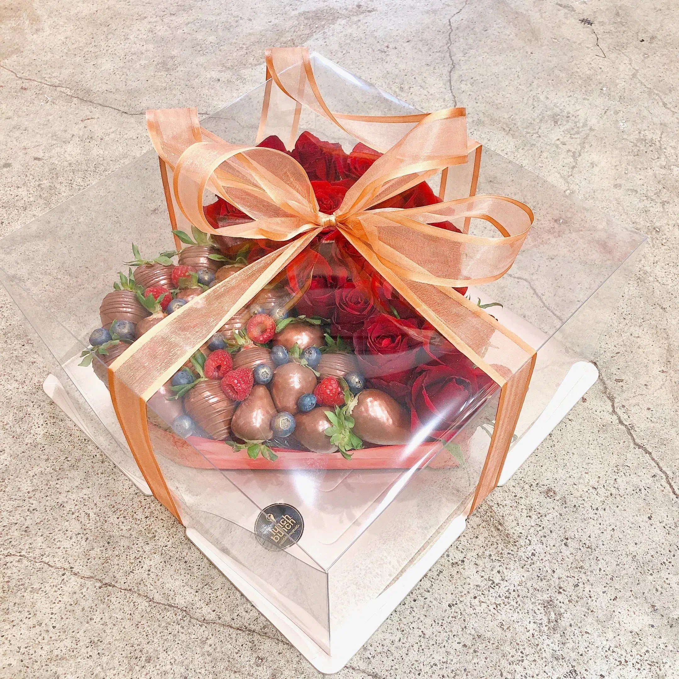 Raspberry flavour macarons with strawberries in love heart shape romantic sweet treat gift box
