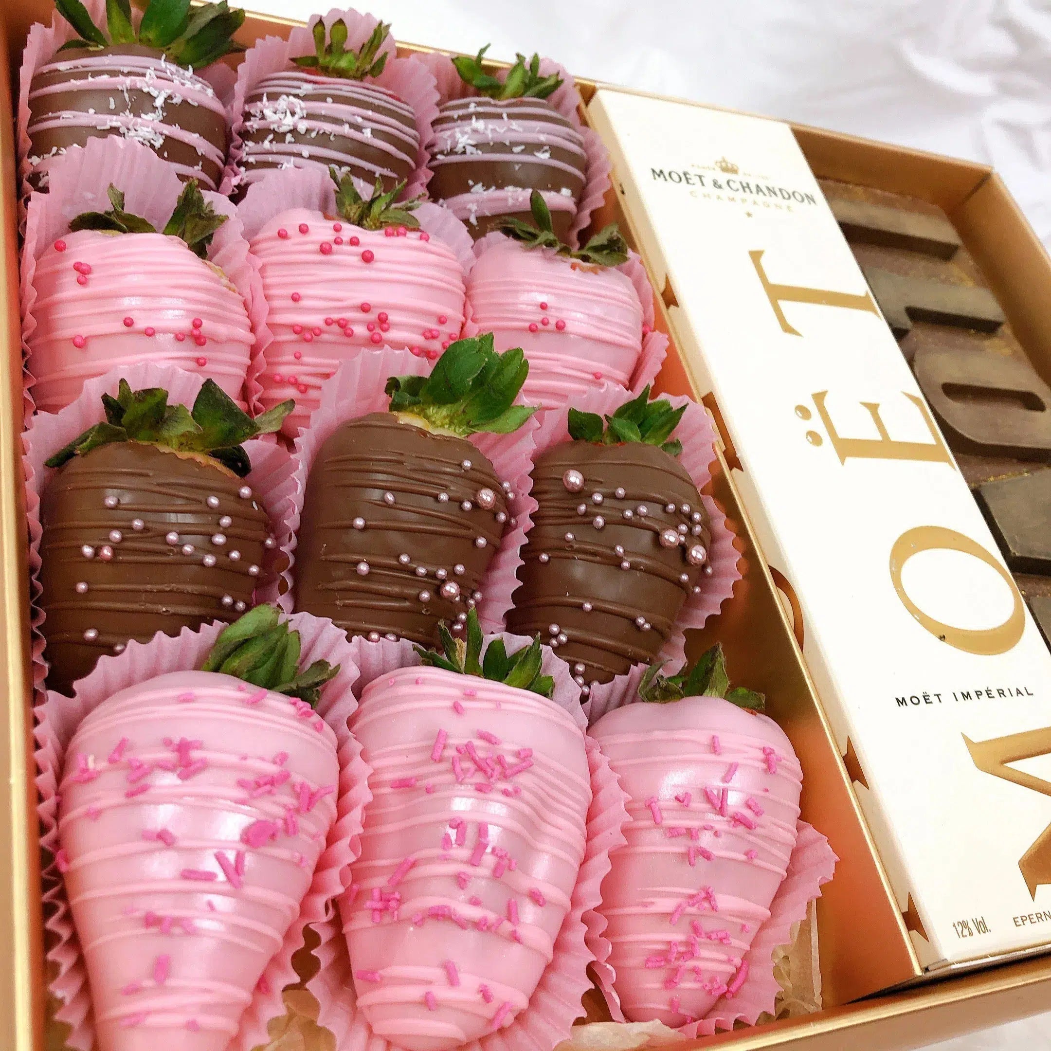 Personalised hamper filled with chocolate covered strawberries and bottle of moet champagne