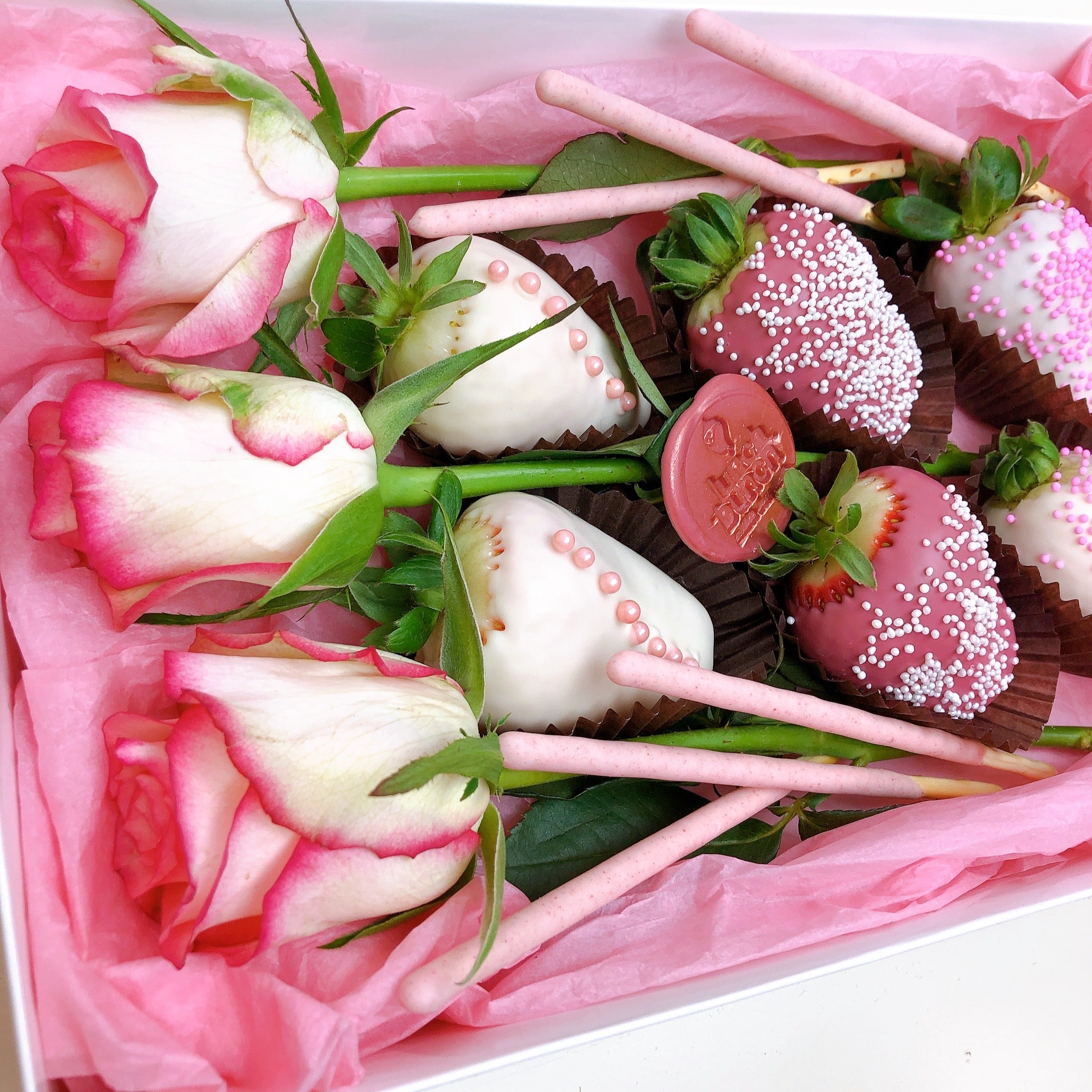 Chocolate covered strawberries and roses in a gift hamper available for same day delivery strawberry box