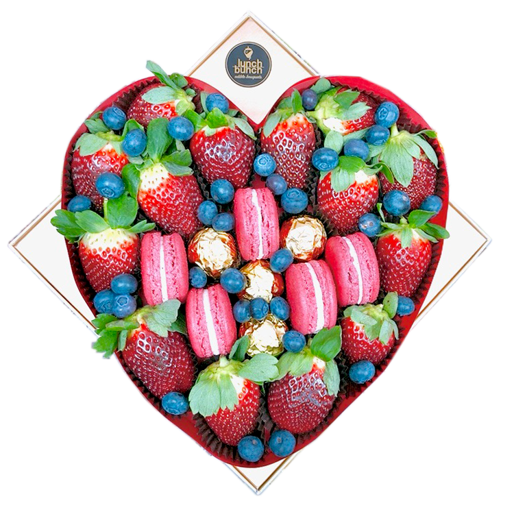 Fresh strawberries and macaroons treat box in love heart shape gift box
