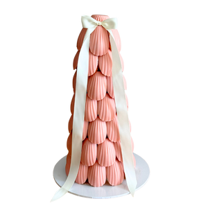 Pink madeleine cake tower glazed in soft pink chocolate, styled as an event dessert centrepiece for baby showers and birthdays in Melbourne and Adelaide.