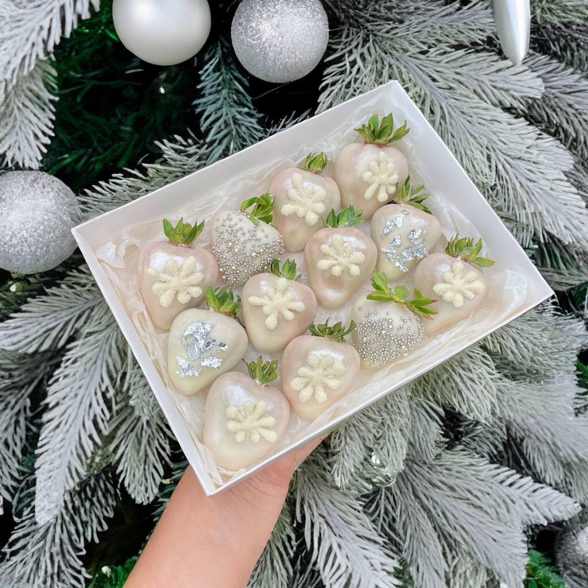 White Christmas chocolate gift, snowflakes and chocolate strawberries in the gift box