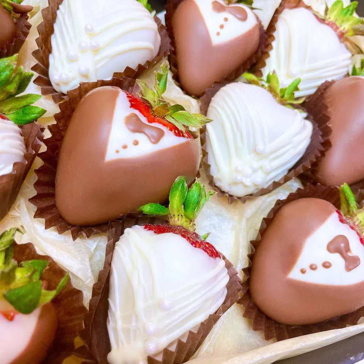 This delightful gift box features a delectable assortment of chocolate-covered strawberries, elegantly decorated in a tuxedo and wedding dress motif. 