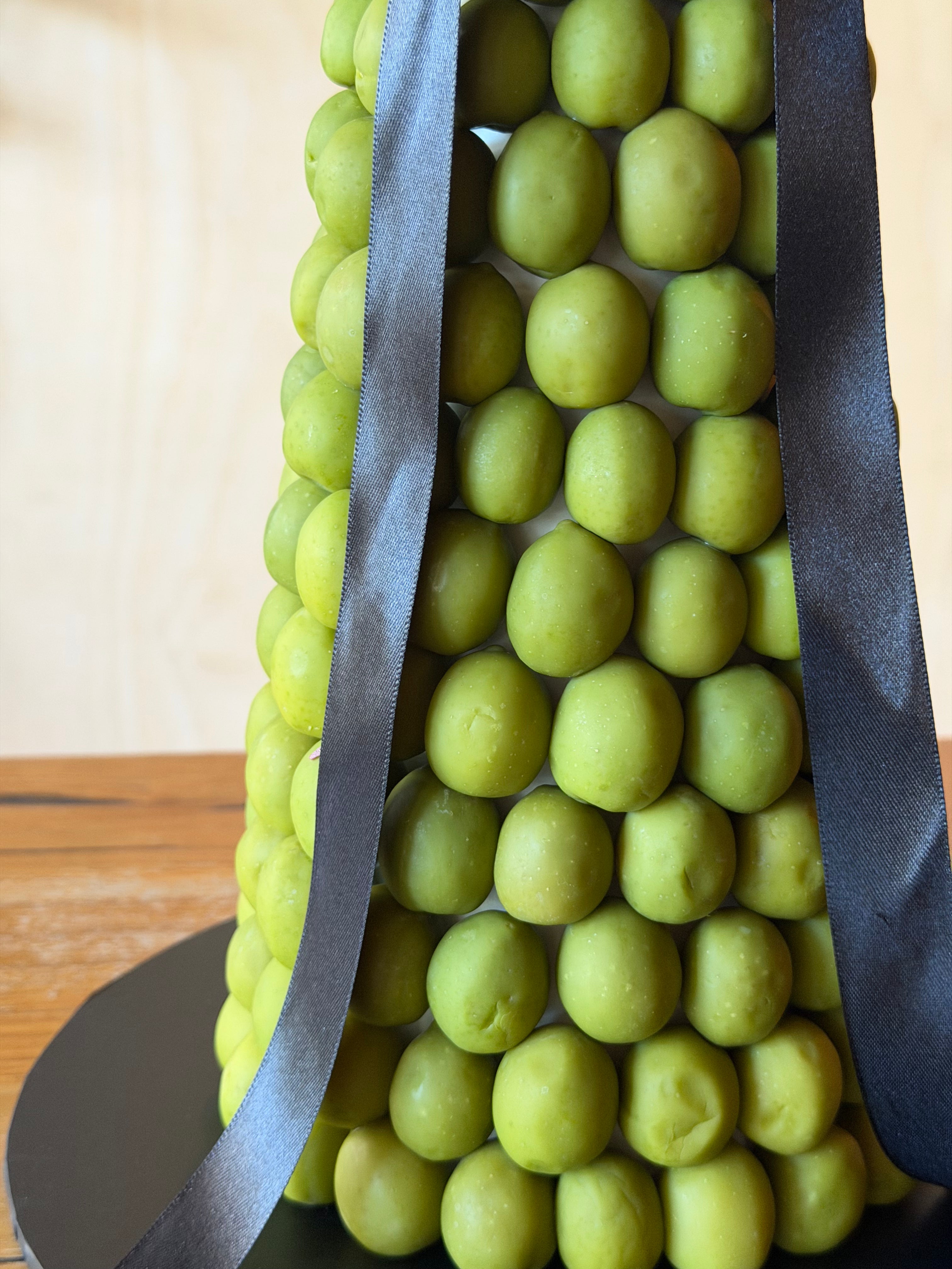 close up of  green olive tower for weddings, events, and cocktail bars