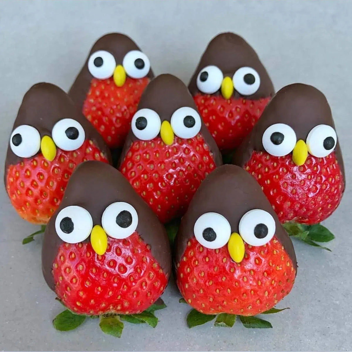 Fresh strawberries decorated as chocolate penguins for a creative kids activity in Camberwell