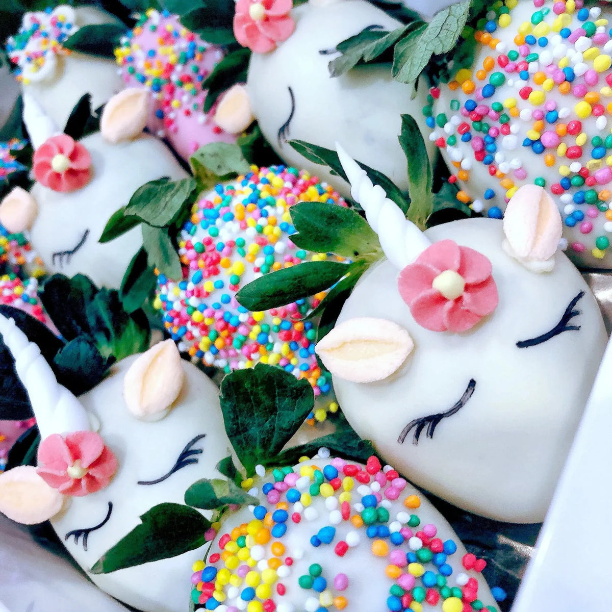 Colourful unicorn chocolate strawberries with sprinkles and edible decorations for a kids creative workshop