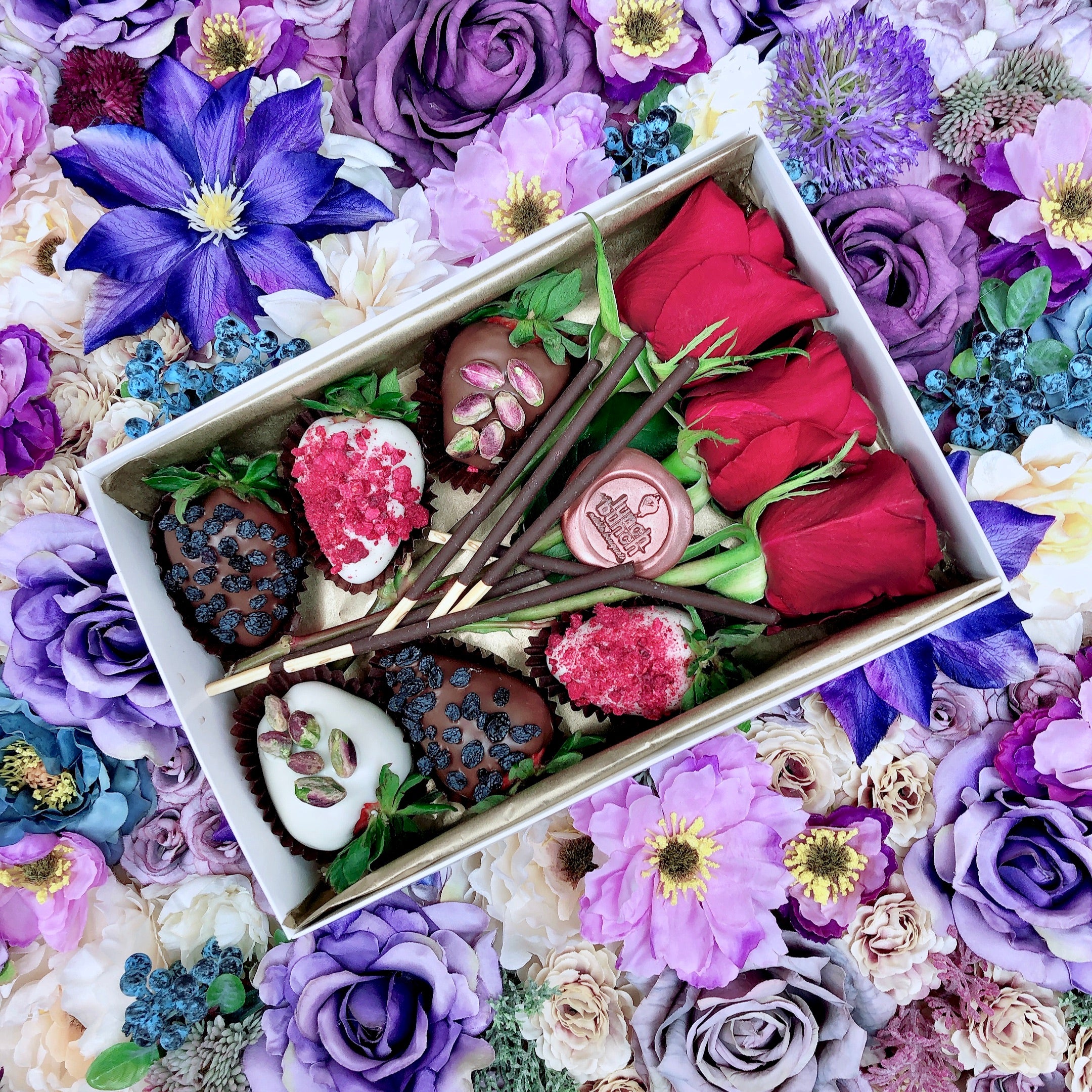Chocolate decorated strawberries with flowers in a small dessert box