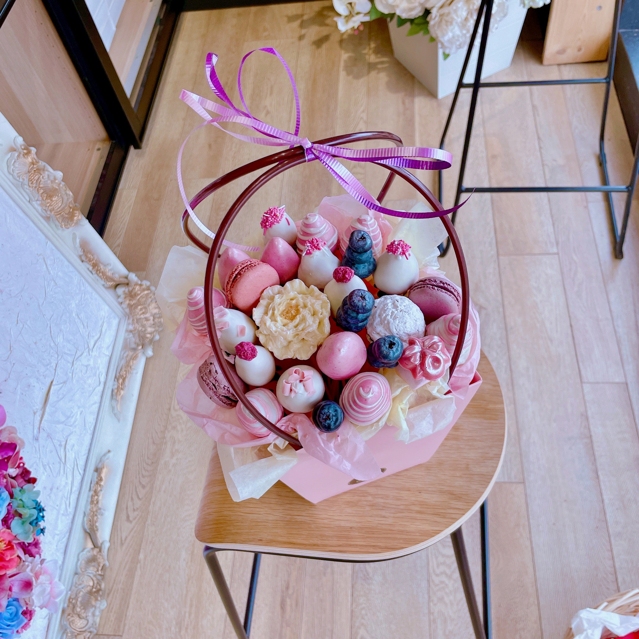 Chocolate dipped strawberries, macarons, and chocolate flowers basket