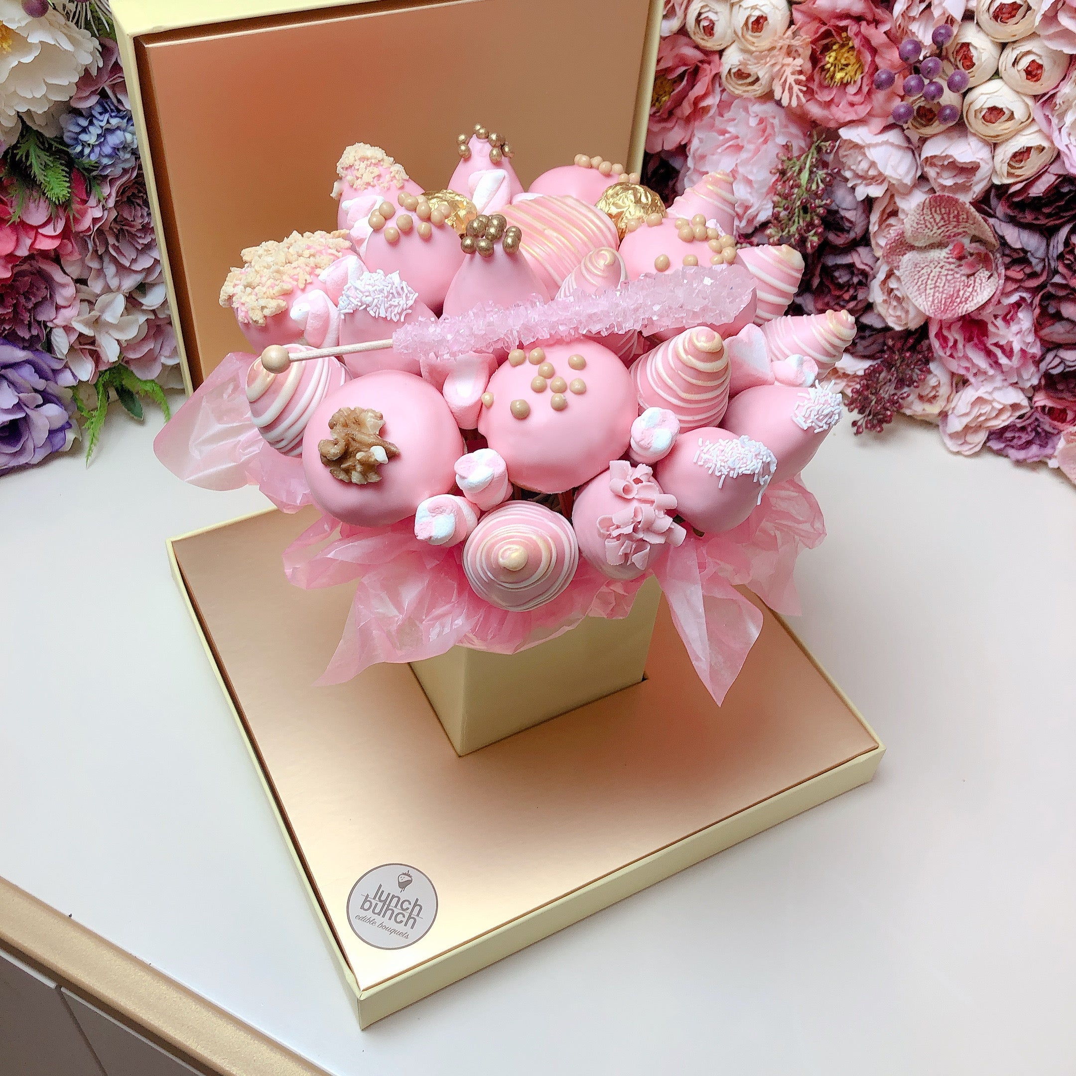 sweet bouquet of chocolate covered strawberries and donuts in pink colour wrapping