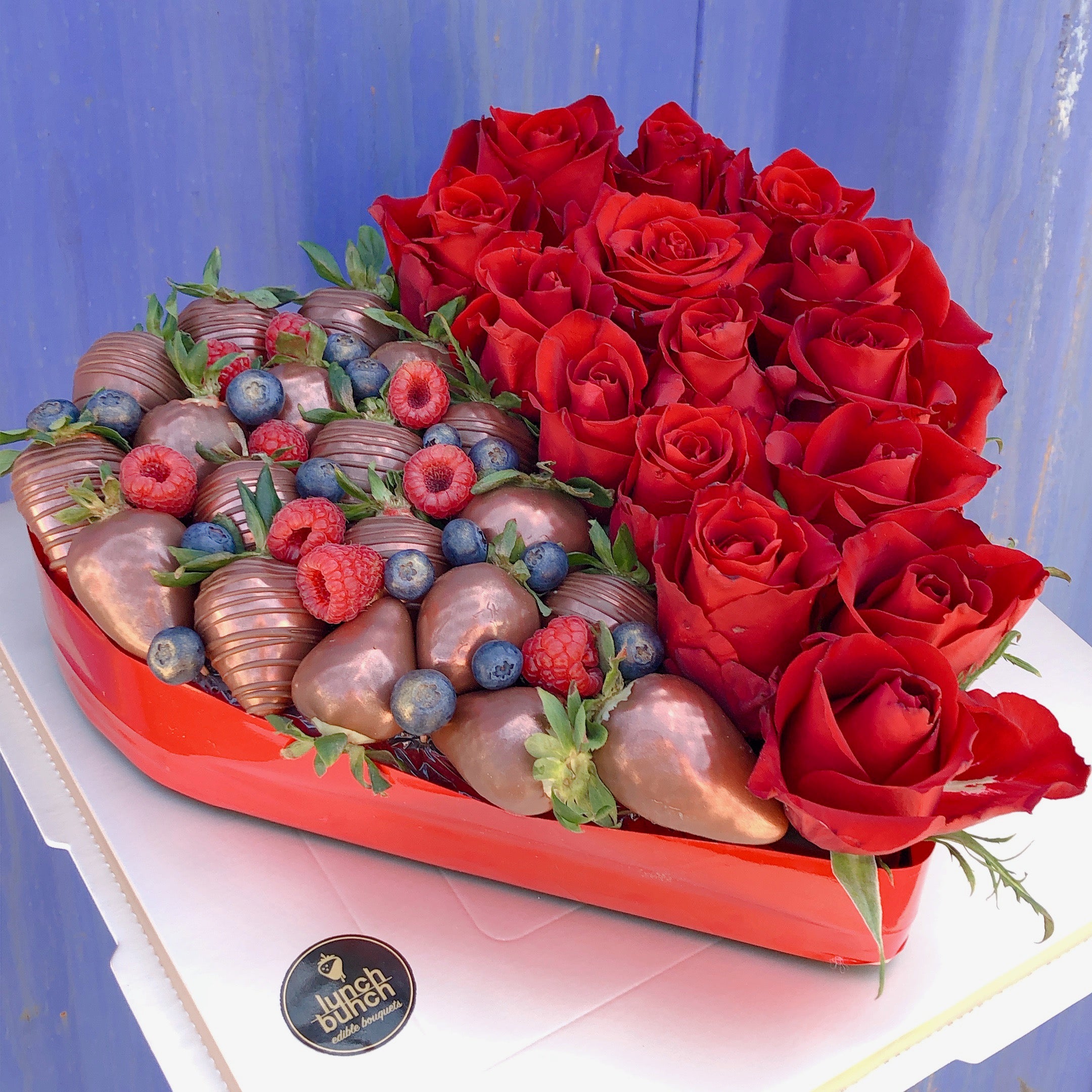 fresh strawberry covered in chocolate in love heart box with roses, heart shape flower box gift with treats
