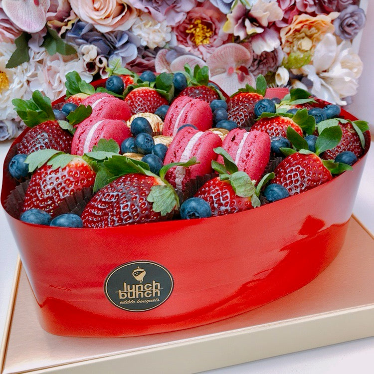 Fresh strawberries love heart shaped box with macaroons and blueberries